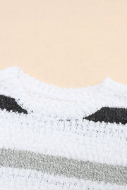 White acrylic sweater with textured stripes and a slouchy knit detail.