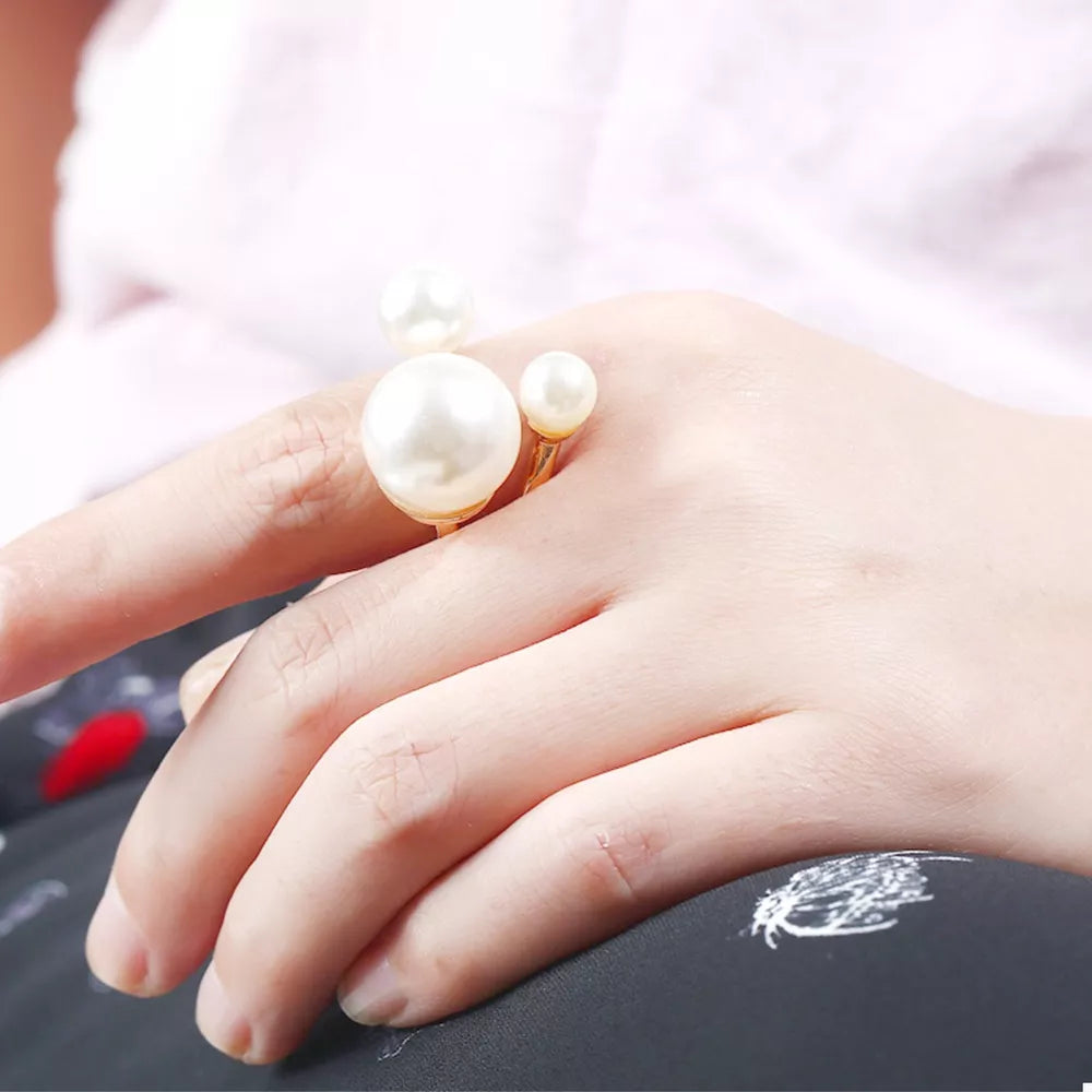 Elegant gold-plated open ring with three pearls on a woman's hand