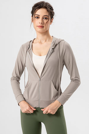 Tan zip-up hoodie with drawstrings, pockets, and a performance fit.