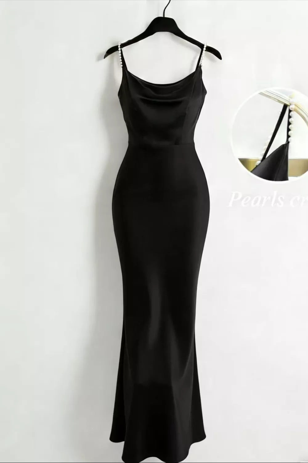 Black satin cowl neck maxi dress with pearl-embellished straps.