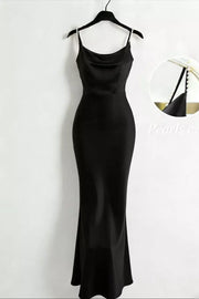 Black satin cowl neck maxi dress with pearl-embellished straps.