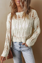 Ivory open-knit crochet crop sweater with diamond pattern and crew neck.