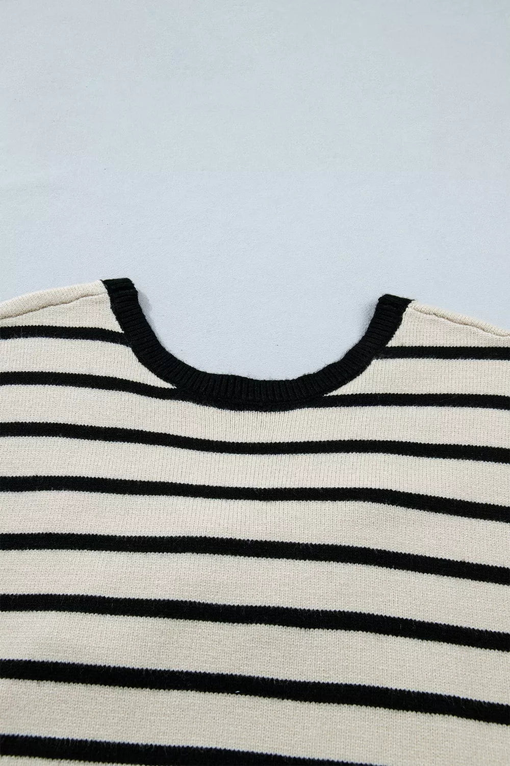 Chic stripe knit top with black trim neckline and black horizontal stripes.
