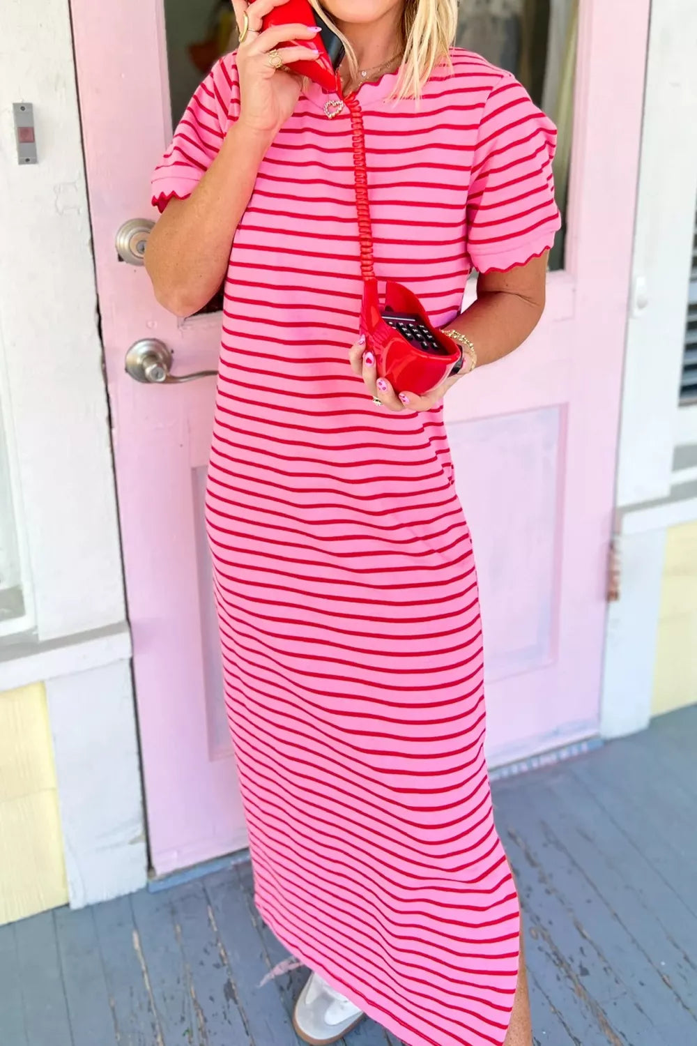 Vibrant striped maxi tee dress in pink and red with scalloped trim and short sleeves.