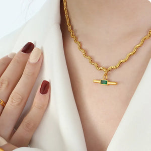 Gold rope chain necklace with emerald bar pendant