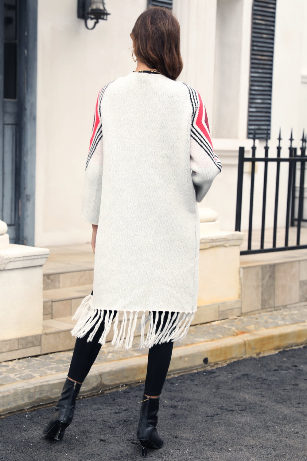 Light grey cardigan with geometric trim on sleeves and fringed hemline.