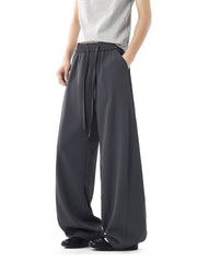 Men's dark gray relaxed wide leg sweatpants with drawstring waist and pockets.