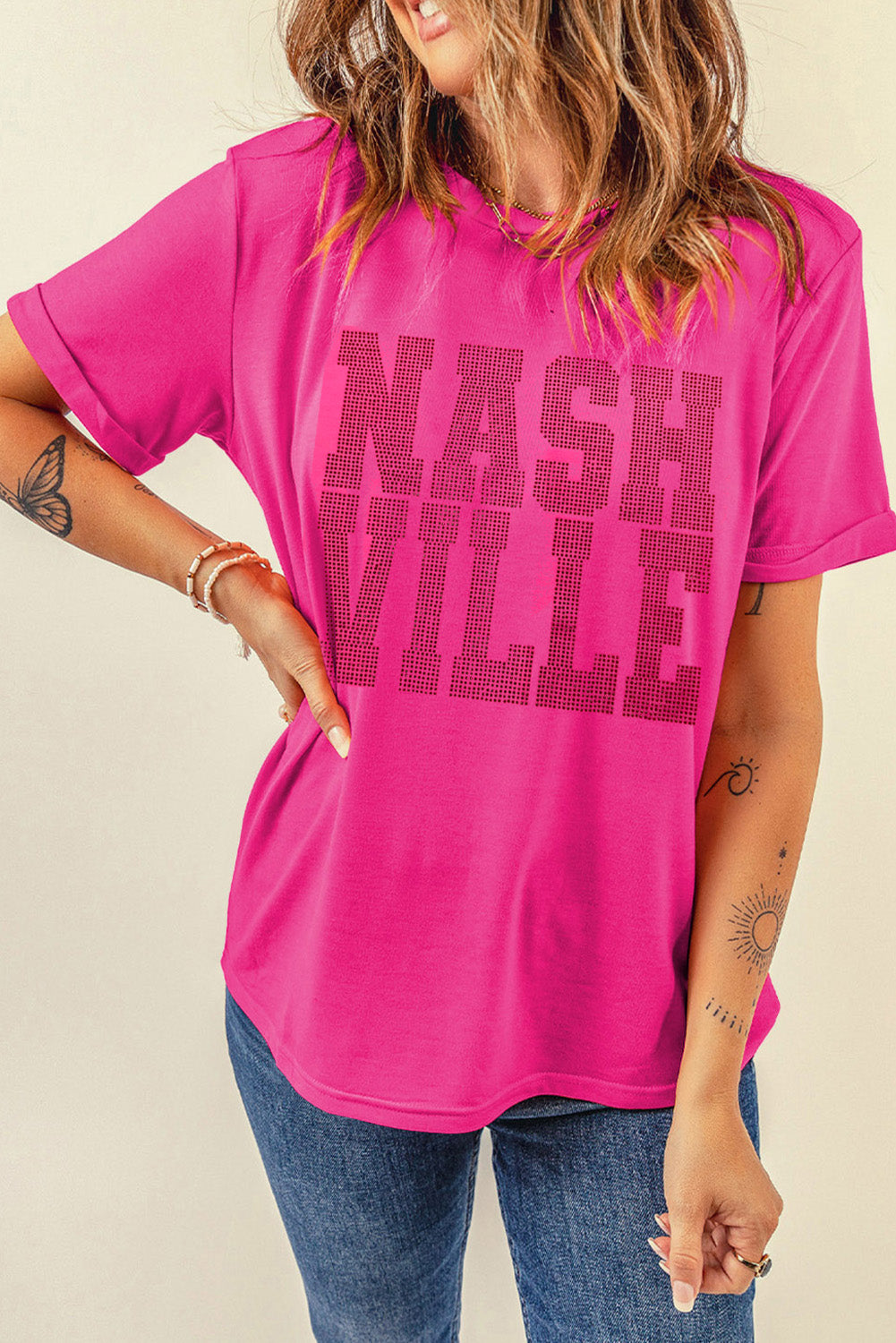 Neon pink t-shirt with rolled sleeves and black "Nashville" text graphic.