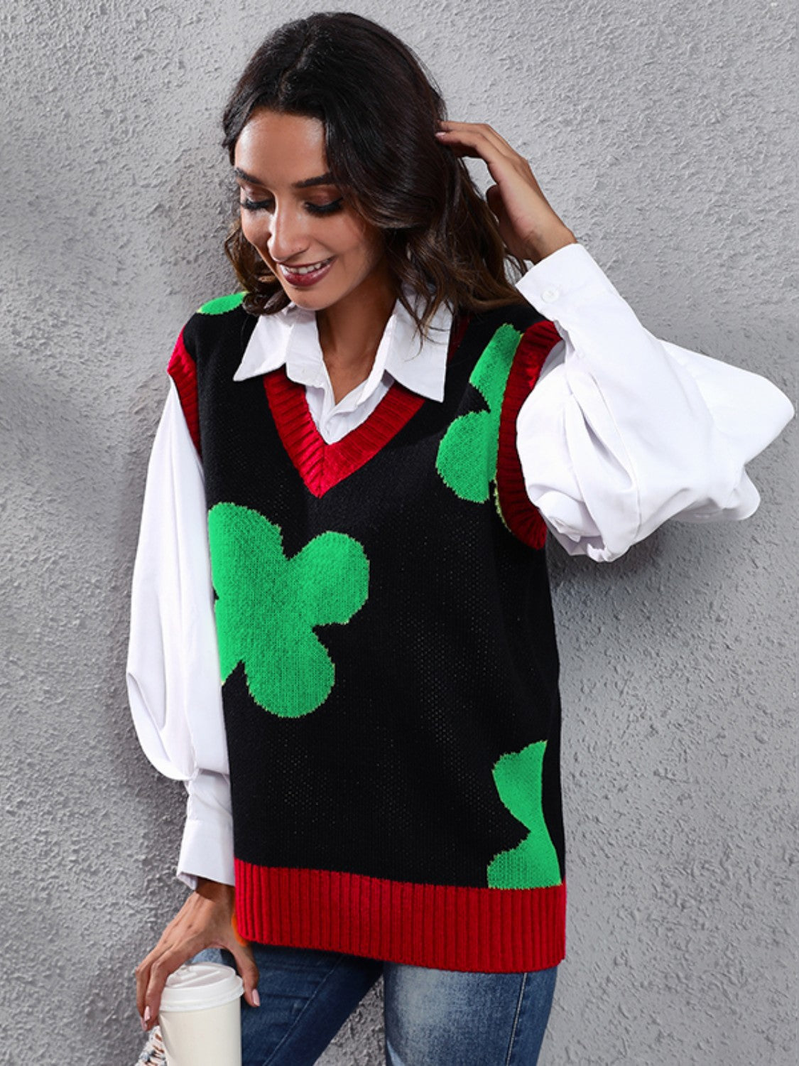 Black acrylic intarsia knit vest with green clover pattern and red trim, V-neck.