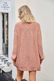 Cable knit cardigan in Burnt Coral with diamond pattern detail on back