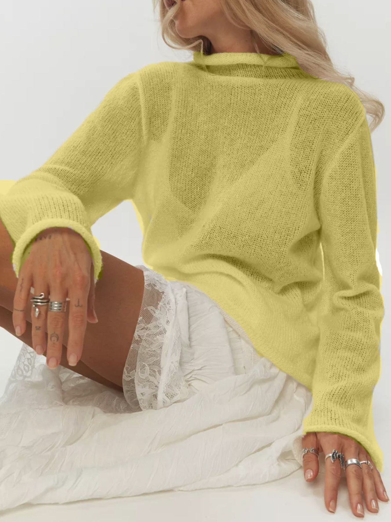 Yellow sheer mock neck knit sweater with long sleeves and a relaxed fit.