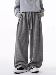 Relaxed fit ribbed knit sweatpants in dark gray with a drawstring waist and pockets.
