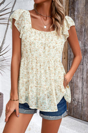 Cream floral peplum blouse with flutter sleeves and square neckline.