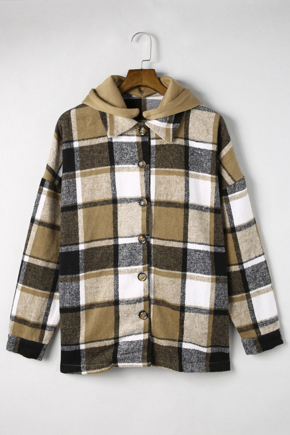 Plaid hooded shacket in tan, black, and white with button front and relaxed fit.