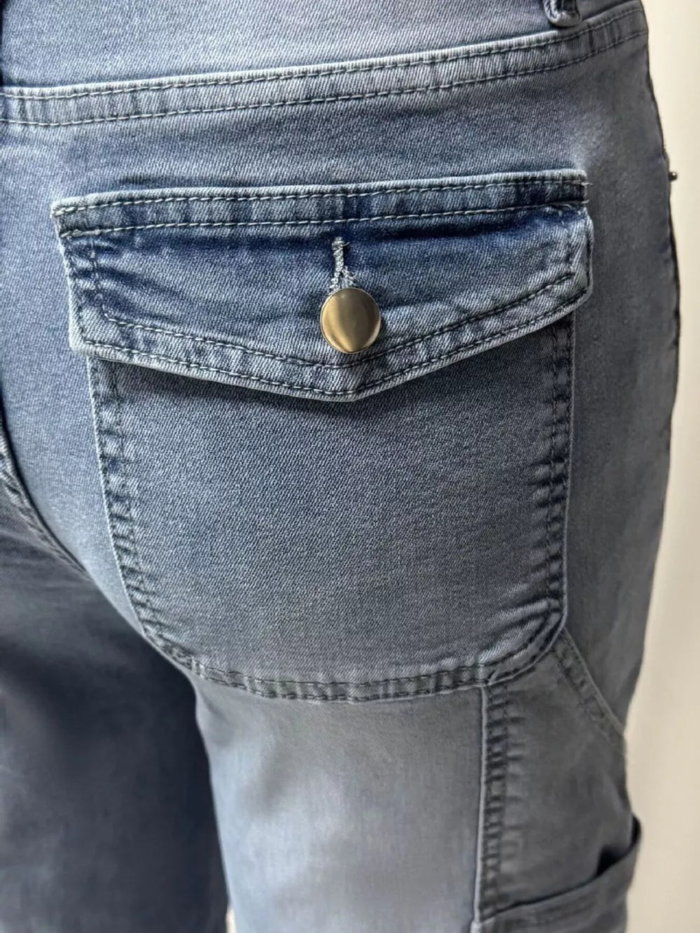 Maternity jeans in light wash denim with a buttoned cargo pocket detail.