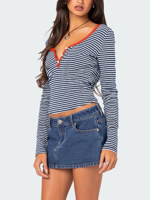 Striped Henley with contrast collar, buttoned neckline, long sleeves, and cropped fit in navy and white.