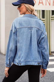 Light blue denim trucker jacket with oversized fit and button details.