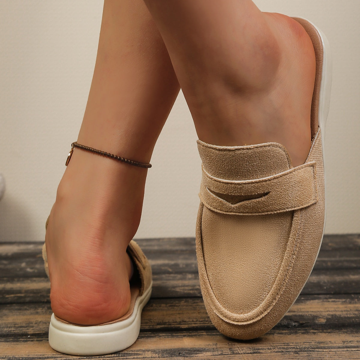 Khaki textured round toe slip-on loafers with a backless design.