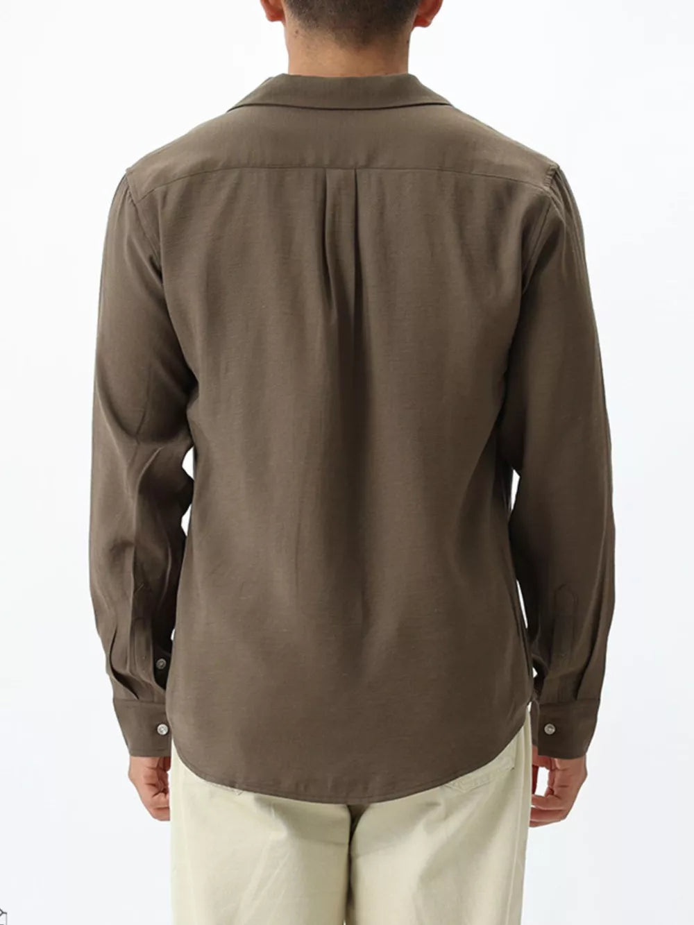 Relaxed camp collar button-up shirt in brown with back pleats and buttoned cuffs.