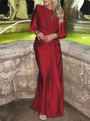 Red ruched knot front maxi dress with long sleeves and a draped skirt.