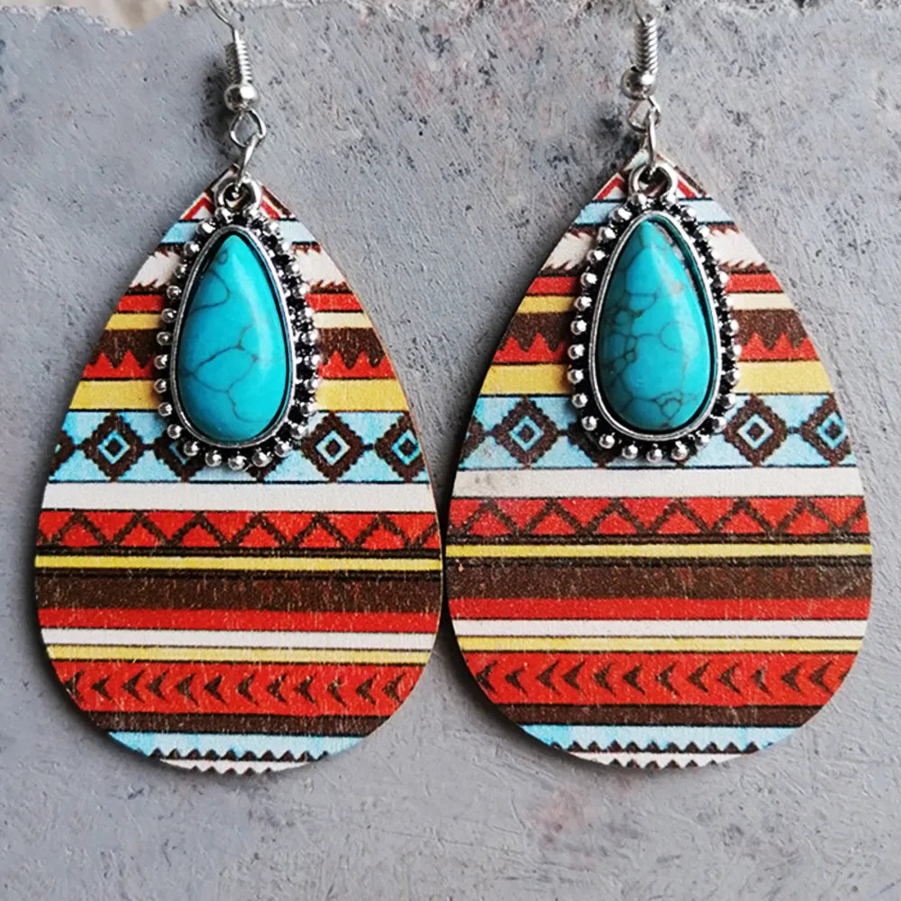 Geo-Turq Teardrop Dangle Earrings with tribal pattern and turquoise stone accent.
