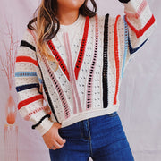 Colorblock openwork knit sweater with multicolor stripes and V-neck detail.