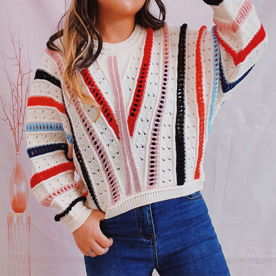 Colorblock openwork knit sweater with multicolor stripes and V-neck detail.
