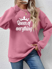 Blush pink graphic sweatshirt with "Queen of Everything" text and crown detail.