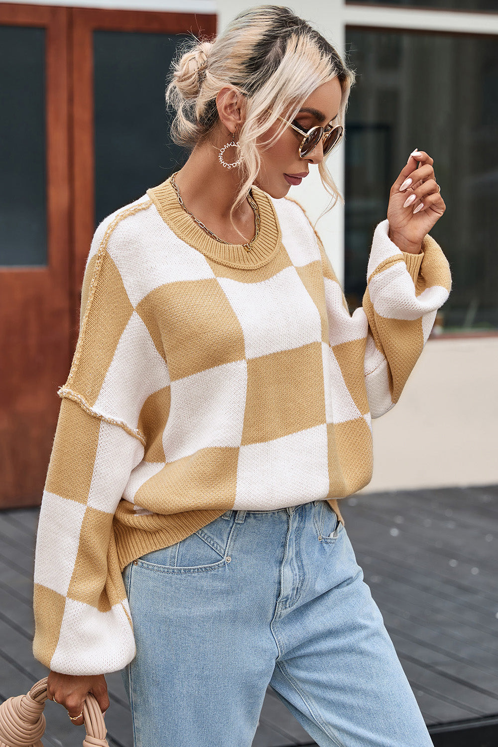 Checkerboard knit relaxed crewneck sweater in tan and white with balloon sleeves.
