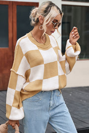 Checkerboard knit relaxed crewneck sweater in tan and white with balloon sleeves.