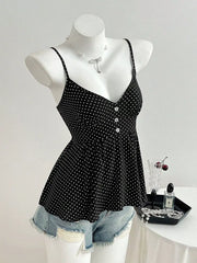 Black polka dot peplum cami with spaghetti straps and button front, styled with denim shorts.