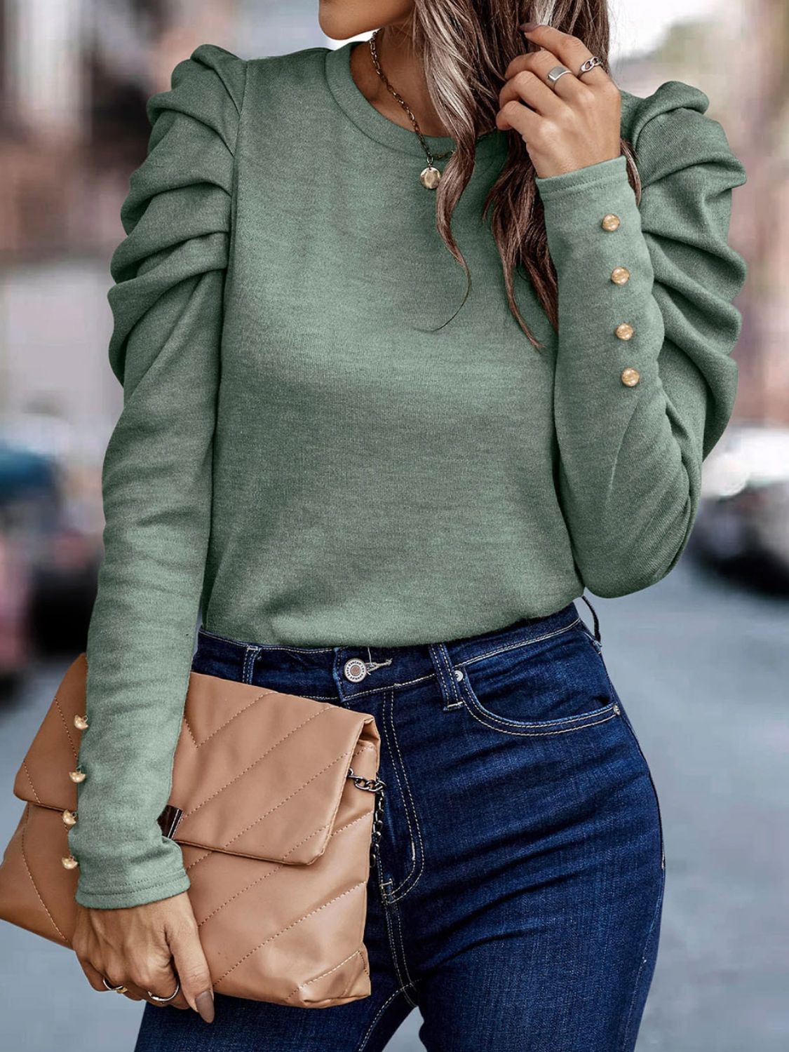 Sage knit top with ruched puff sleeves and gold button cuffs.