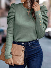 Sage knit top with ruched puff sleeves and gold button cuffs.