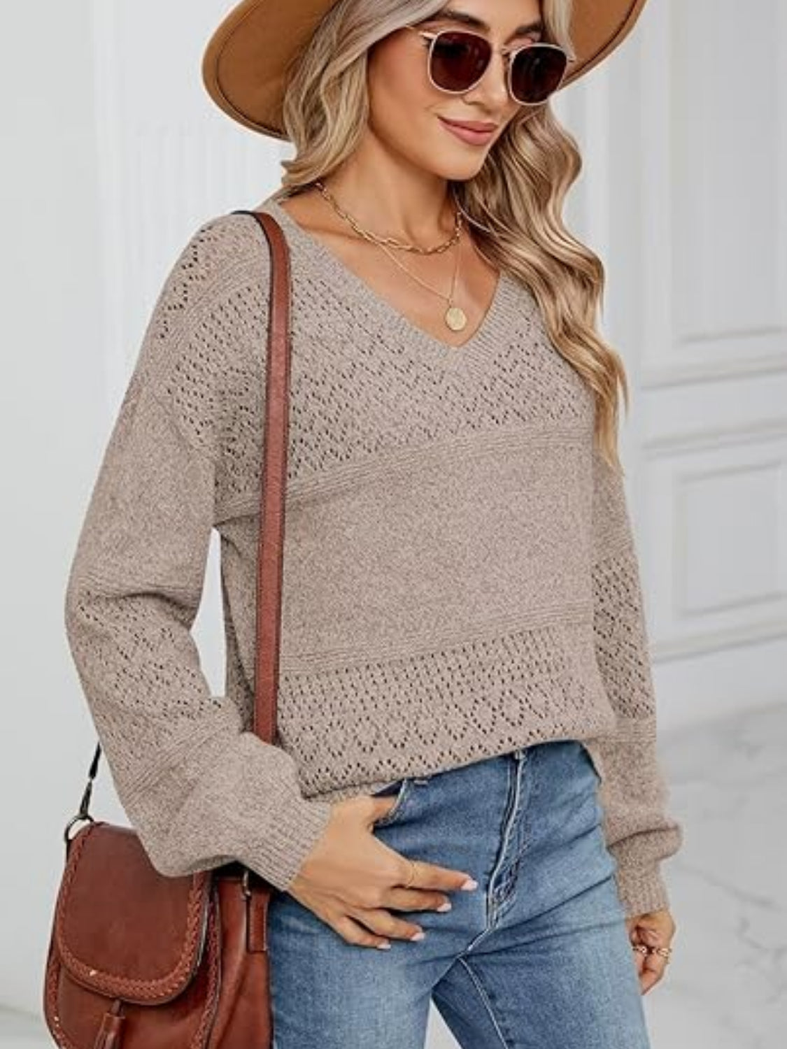 Tan eyelet stitch V-neck pullover sweater with long sleeves and textured detail.