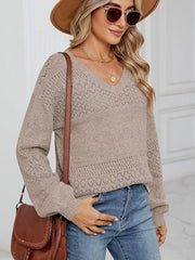Tan eyelet stitch V-neck pullover sweater with long sleeves and textured detail.