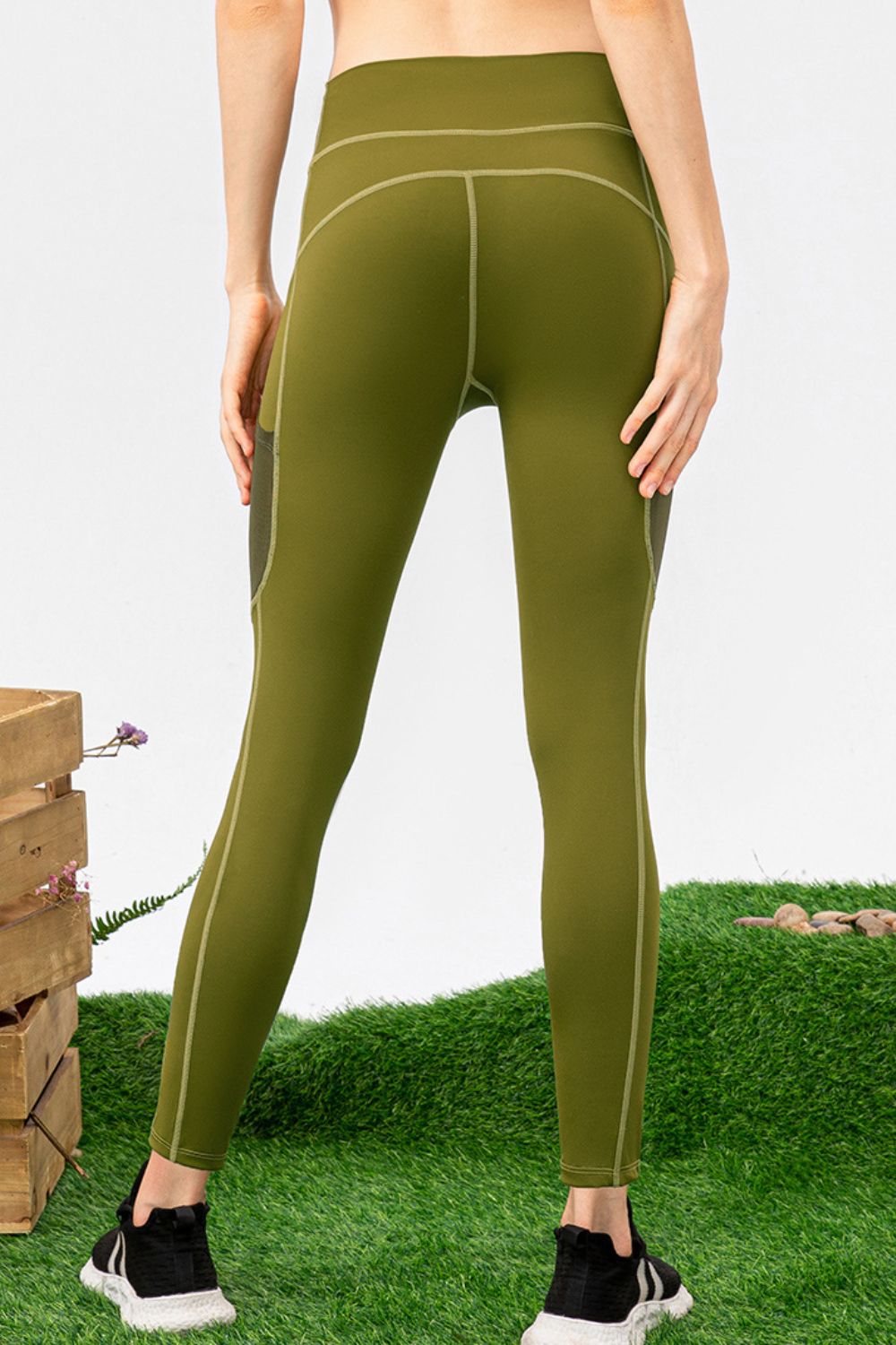 Matcha green performance leggings with mesh pockets and contrast stitching.
