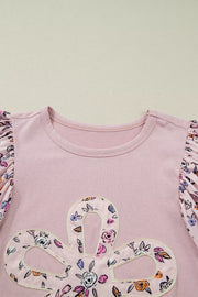Pink cotton crew neck maternity shirt with floral patchwork sleeves and applique detail.