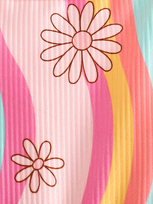 Baby jumpsuit with floral print and rainbow stripes in pink, yellow, and blue.