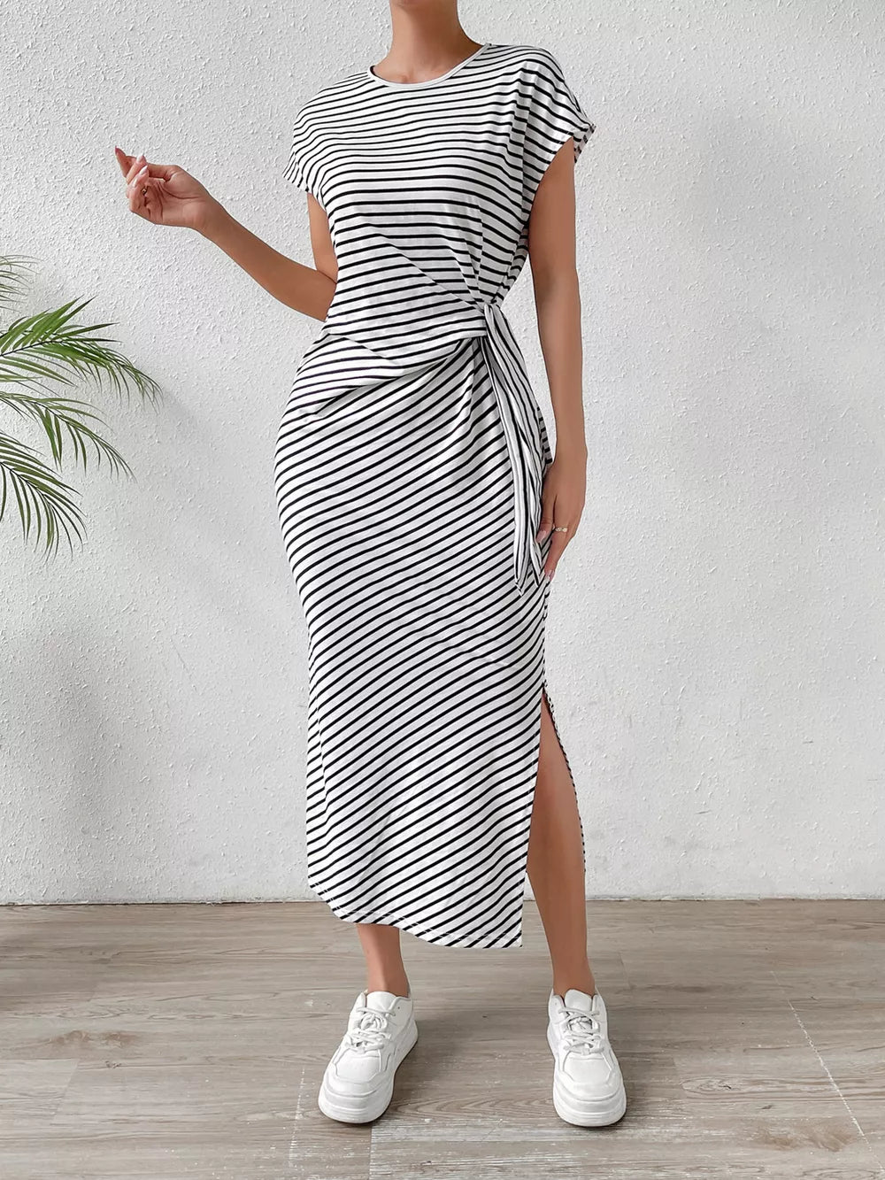 Black and white striped midi dress with tie-side detail and thigh slit.