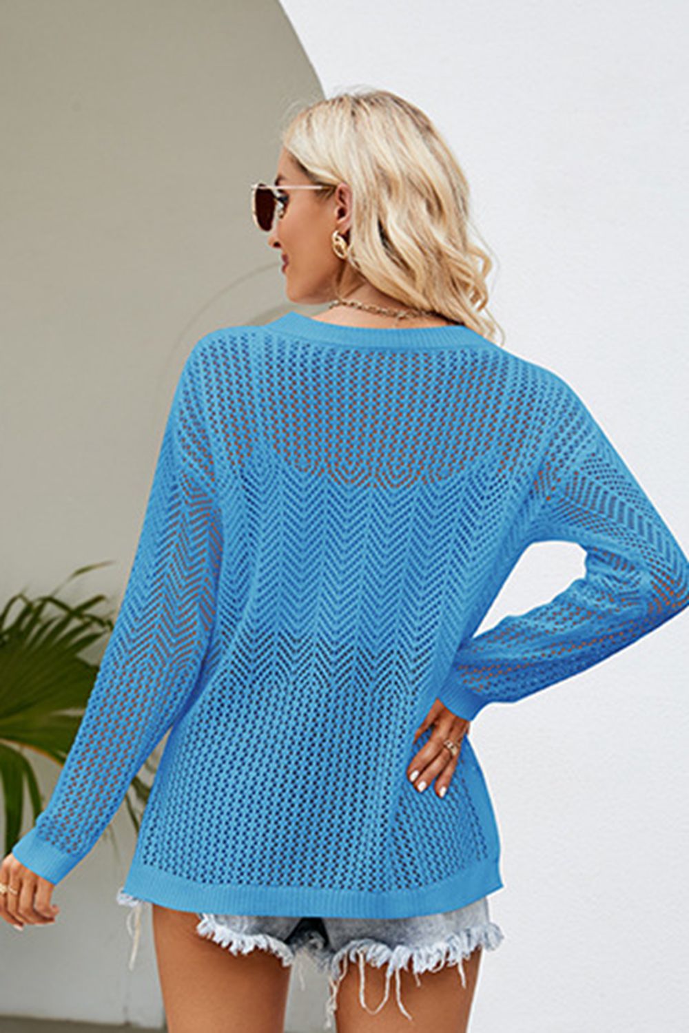 Sky blue openwork knit tunic with chevron pattern and long sleeves.