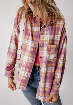 Oversized pink plaid button-down flannel shirt with a chest pocket and button cuffs.