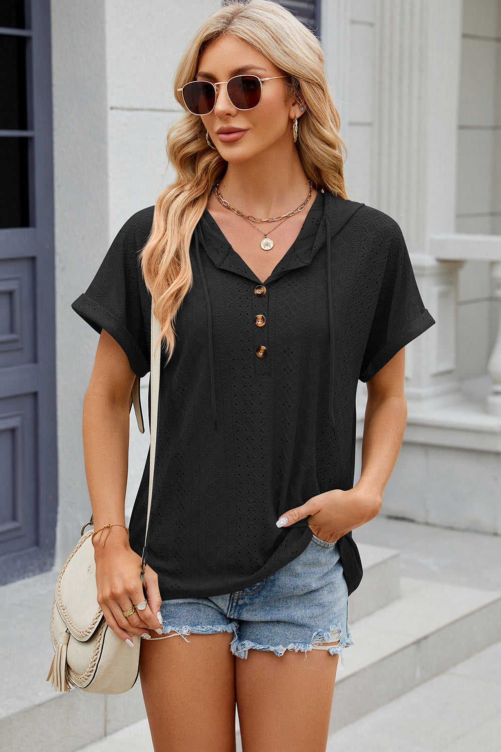 Black perforated henley hooded tee with short sleeves and button detail