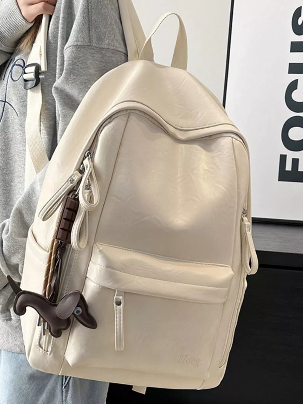 Chic pu leather medium backpack in white with a dachshund charm and front pocket.