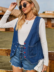 Indigo denim vest with red heart buttons and front pockets, worn over a white long-sleeve shirt.