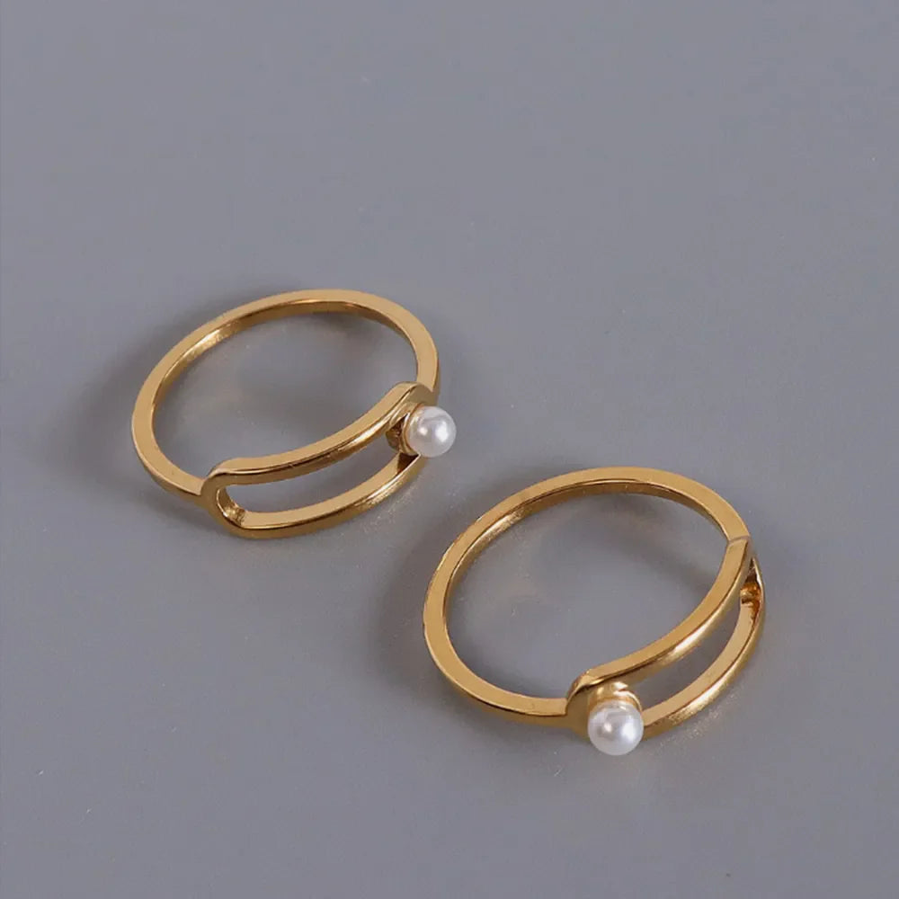Gold sculptural ring with pearl accent, minimalist modern jewelry