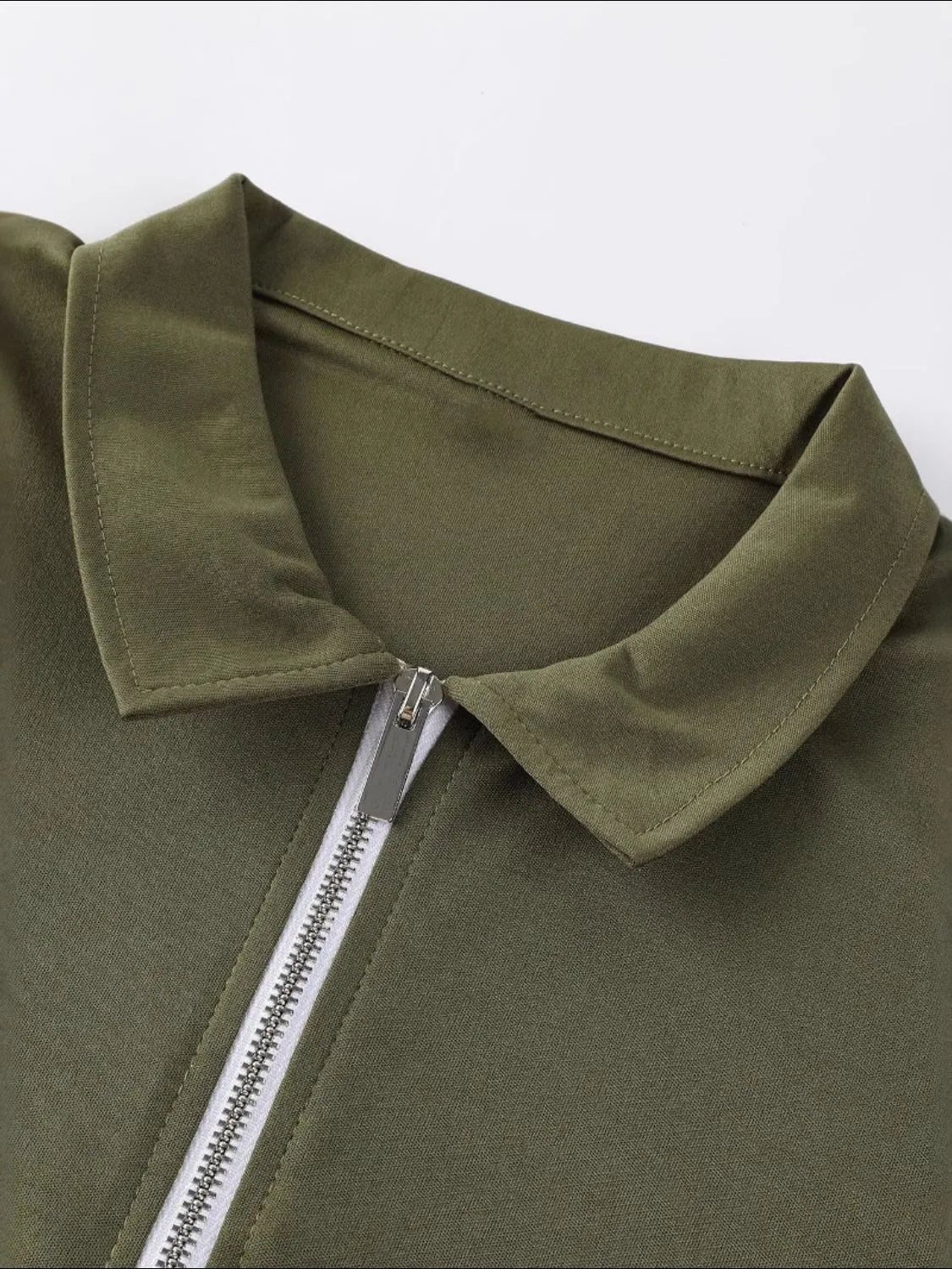 Moss zip-front polo shirt with a silver zipper and collar detail.
