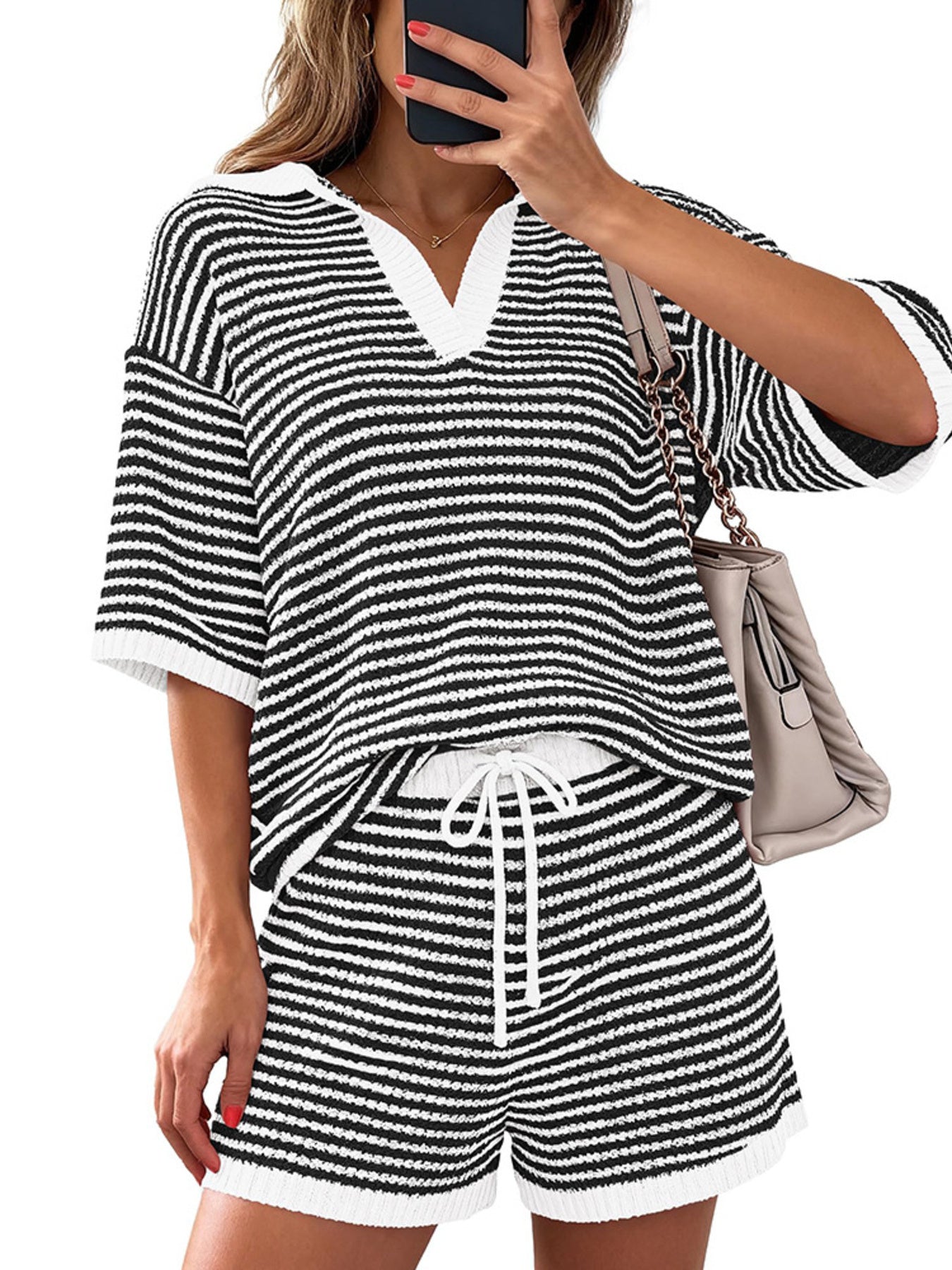 Striped knit polo shirt and drawstring shorts set in black and white.