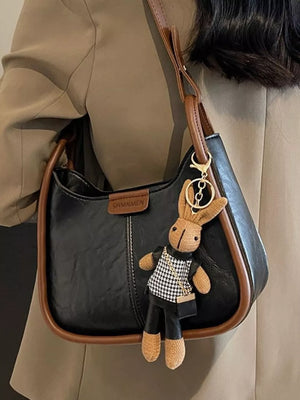 Black pu leather shoulder bag with brown piping and bunny charm