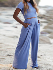 Cloudy blue pleated waist crop top and wide leg pants set with pockets.