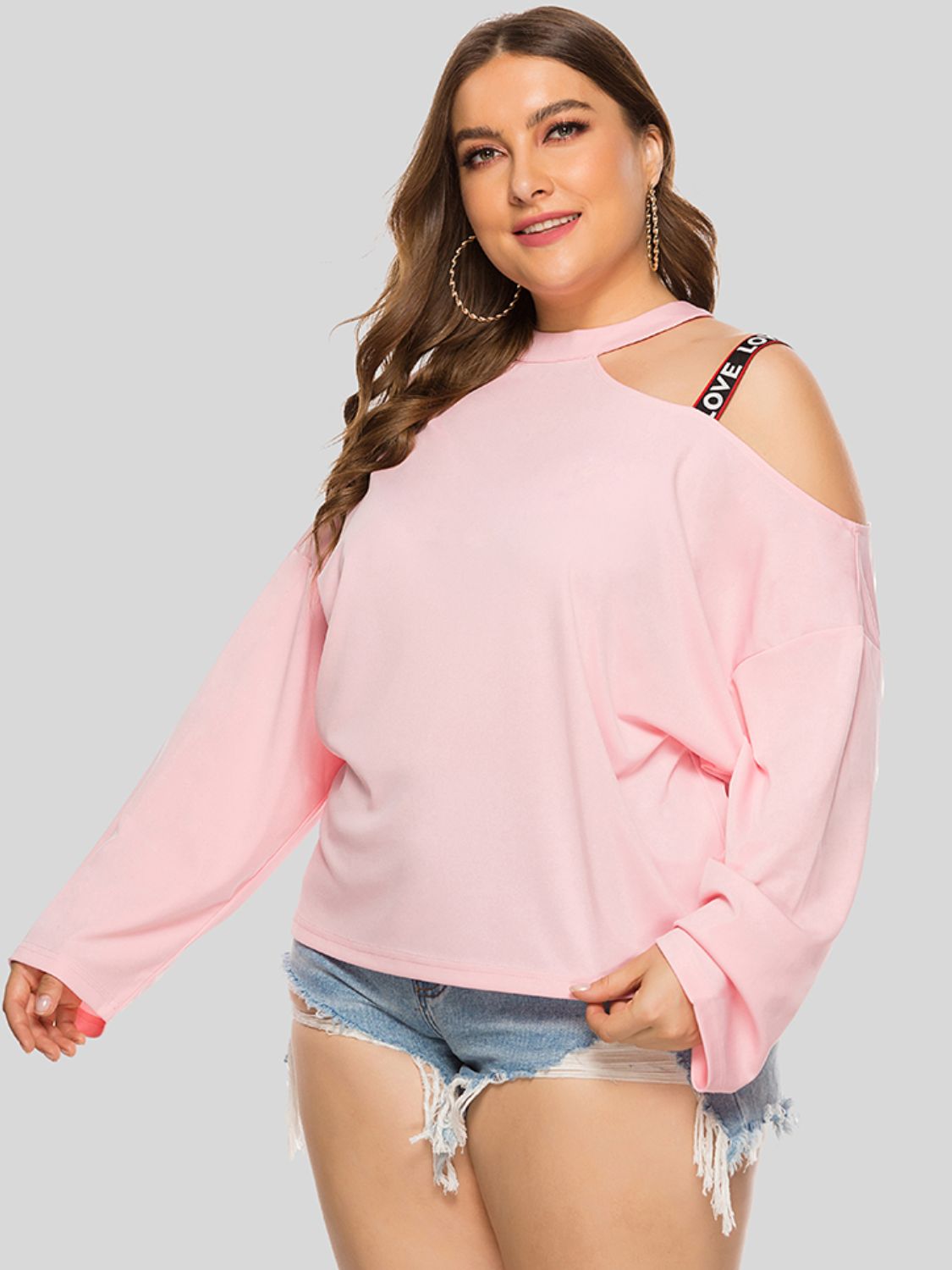 Blush pink sweatshirt with cold shoulder cut-outs and "LOVE" strap detail
